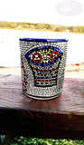 longdesc=" Large Mosaic Glazed Ceramic Mug that has two Red yellow Fishes and a blue and green basket containing round red and yellow pieces of bread loaves, which have been pattern pressed with a mosaic shape in black color. The almost square mosaic bord