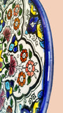 Pierced hanging Ceramic Wall Plates - Colorful Teleido Dance - Red yellow dark blue & light blue colorful teleidoscope patterns on glazed earthenware ceramic flat plates. Own&Adore Mystic Land Painted Creations. Eid Decorations. Palestinian pottery art and ceramic
