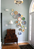 Pierced hanging Ceramic Wall Plates - Colorful Teleido Dance - Red yellow dark blue & light blue colorful teleidoscope patterns on glazed earthenware ceramic flat plates. Own&Adore Mystic Land Painted Creations. Eid Decorations. Palestinian pottery art and ceramic